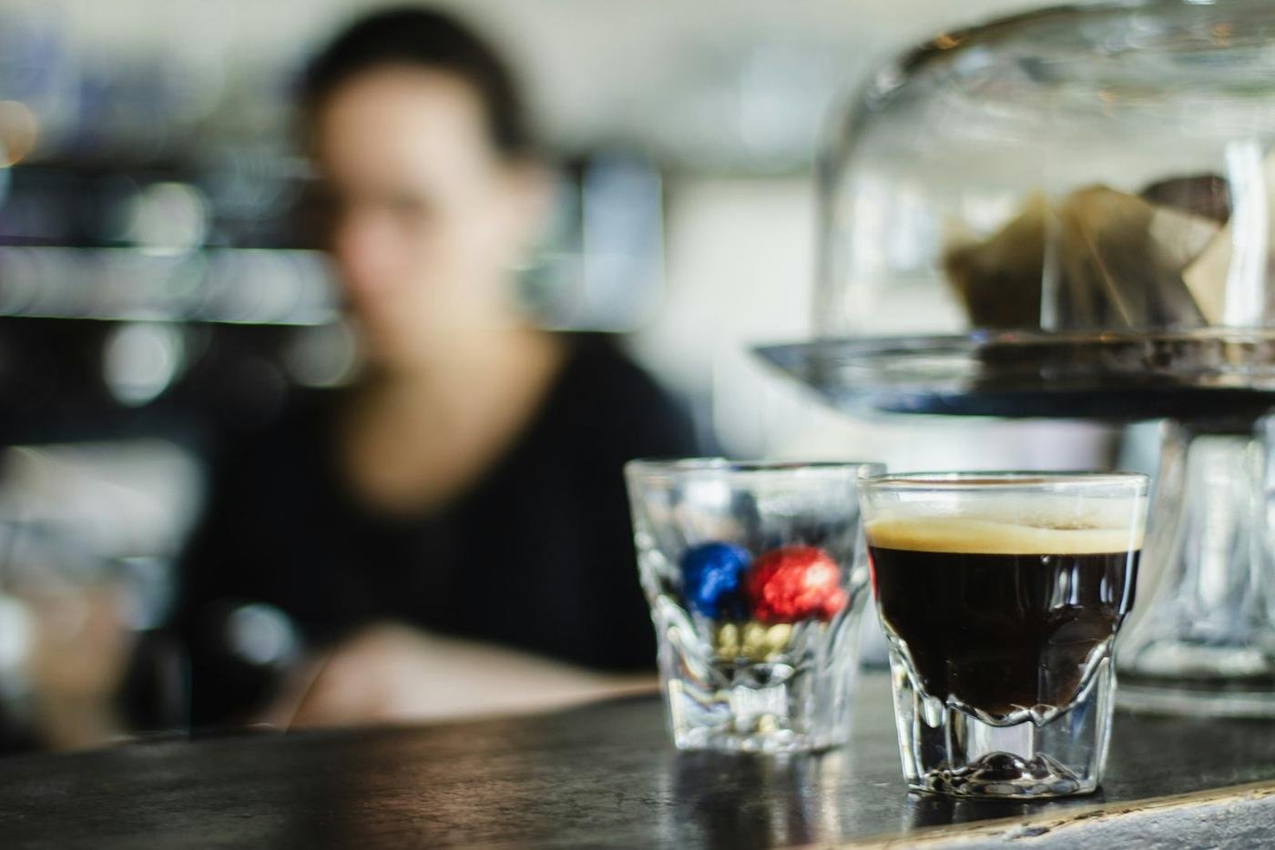 A barista behind an espresso machine