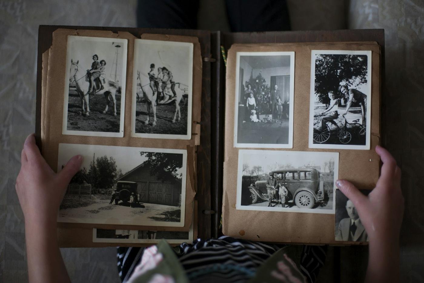 An open family album with black-and-white photos