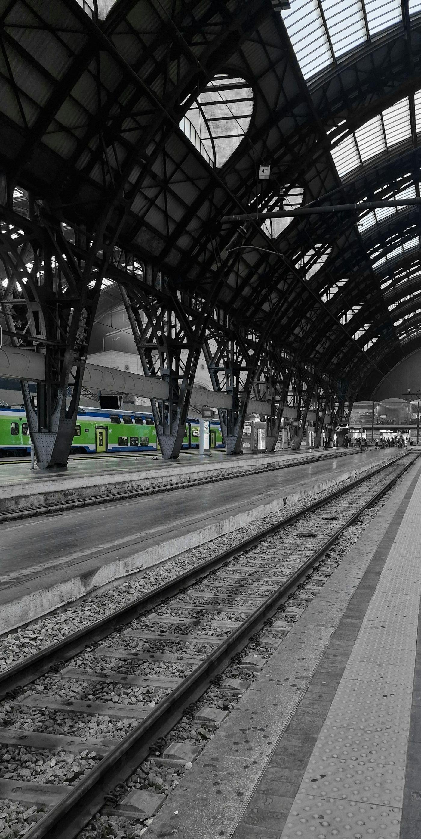 Trains waiting under the roof of an Italian railway station