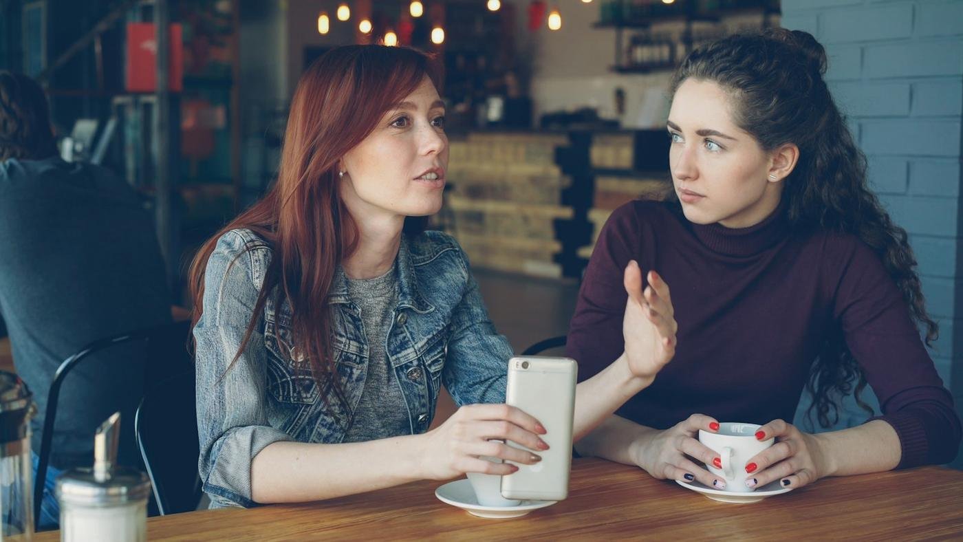 Two women talking over coffee in a café